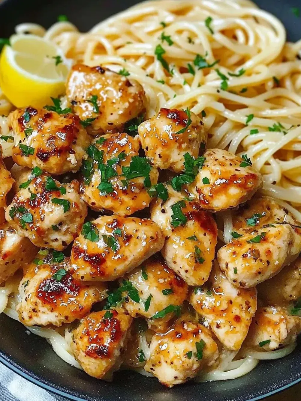 A plate of chicken and pasta.