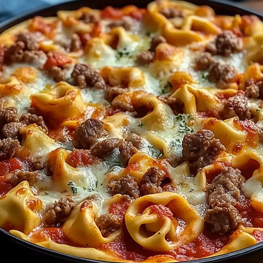 A pizza with meat and noodles.