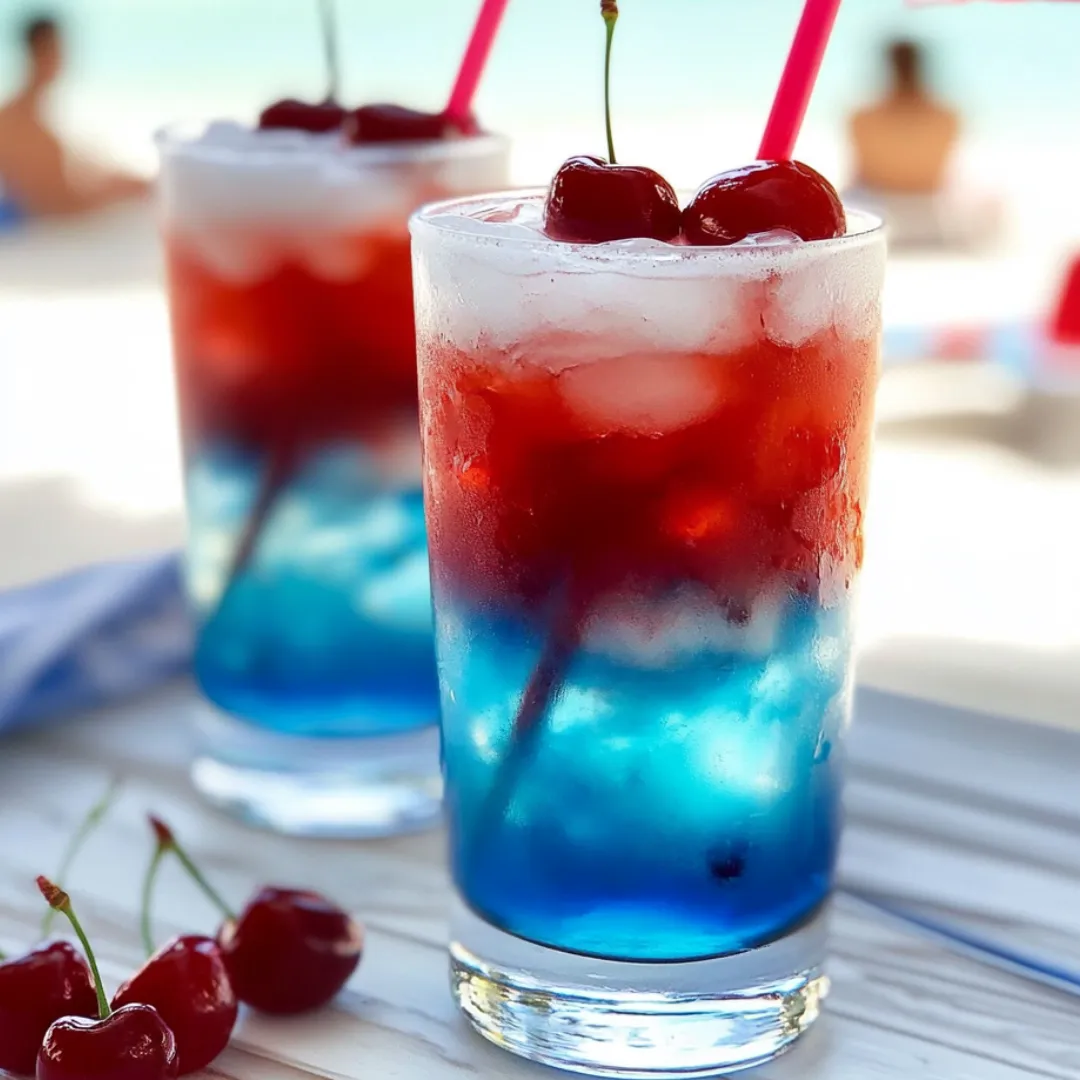 Two glasses of cherry limeade with cherries on the side.