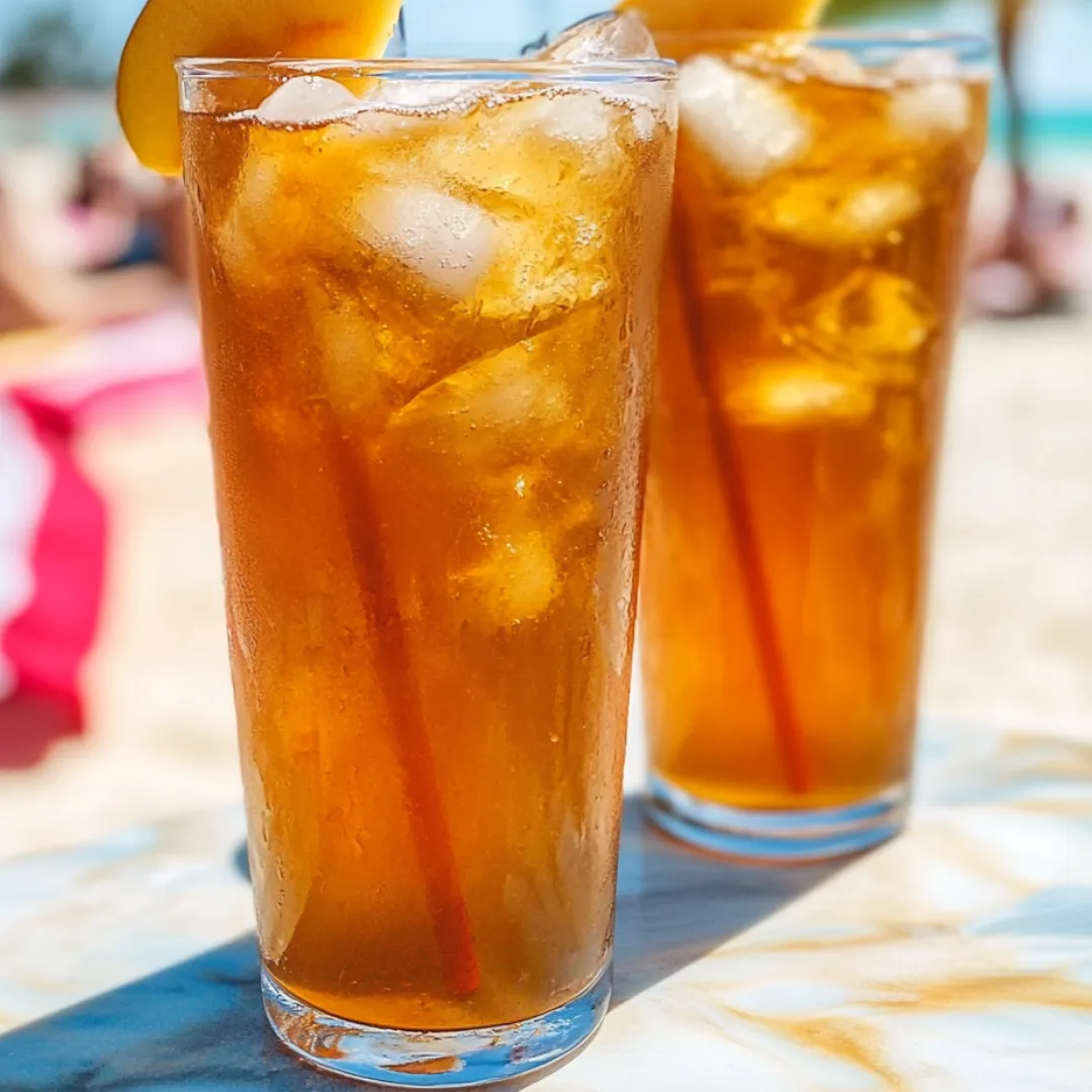 Two glasses of iced tea on a table.