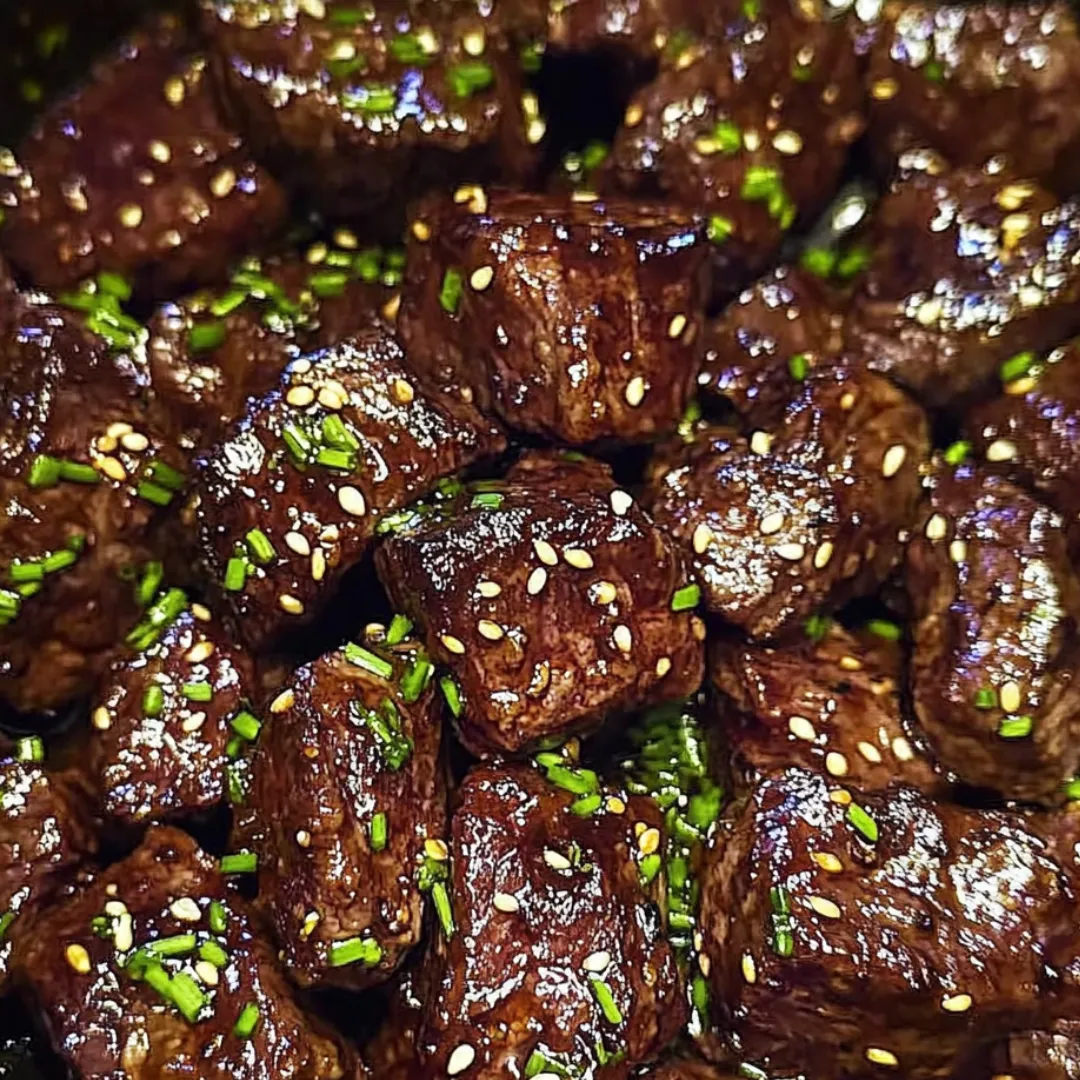 A close up of meat with green toppings.