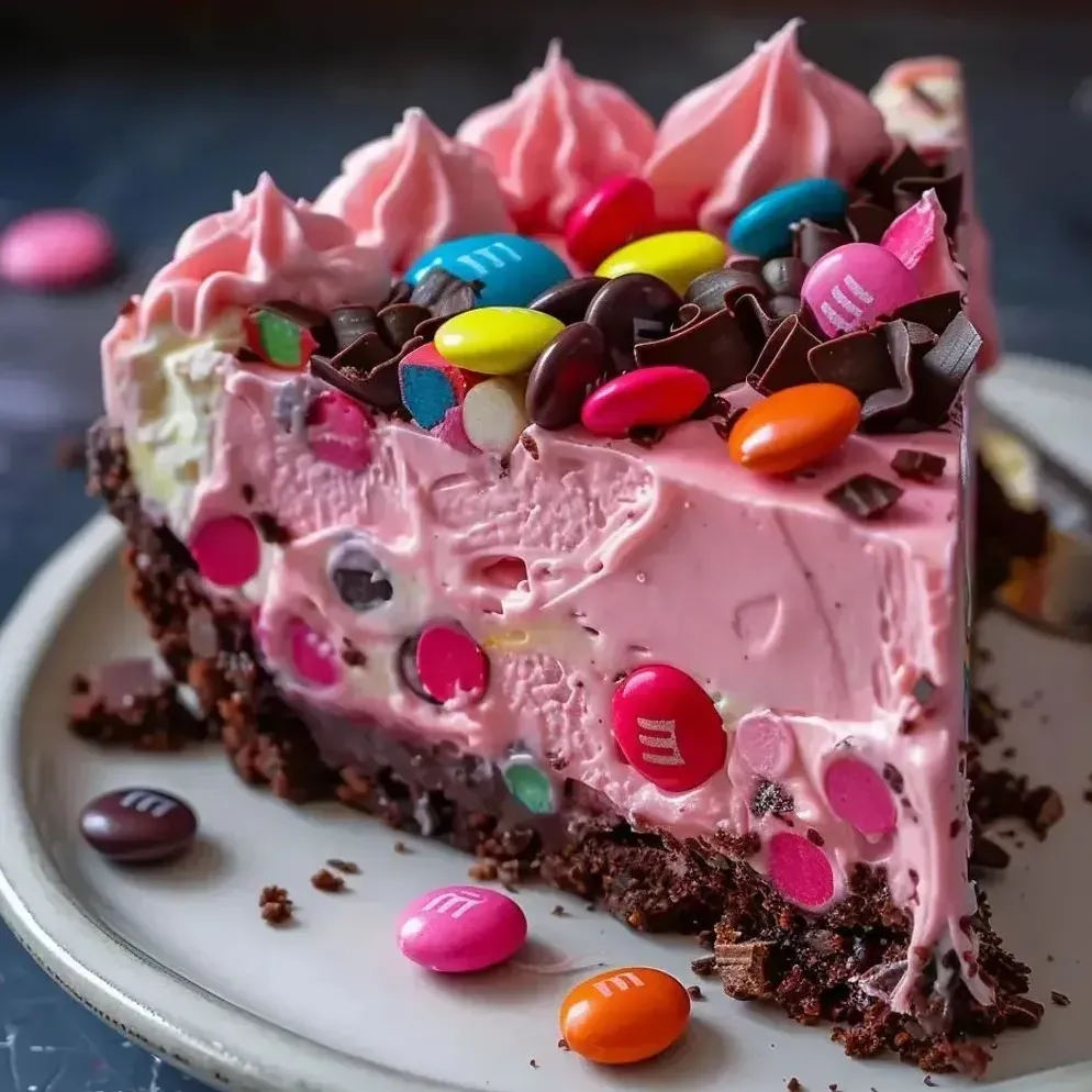 A slice of cake with chocolate and candy toppings.