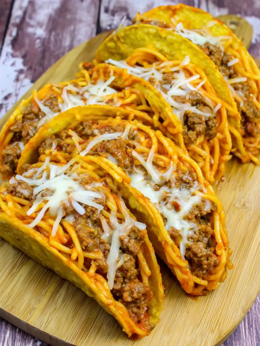 A plate of food with a spaghetti and meat sauce topping.