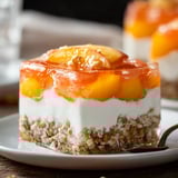 A slice of peach cobbler on a plate.