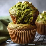 A green muffin with white topping.