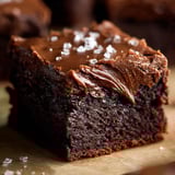 A slice of chocolate cake with chocolate frosting.