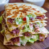 A stack of bacon and lettuce sandwiches.