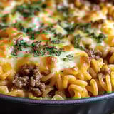 A pan of food with cheese and meat.