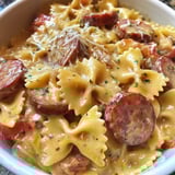 A bowl of pasta with meat and cheese.
