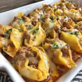 A white bowl filled with pasta and meat.
