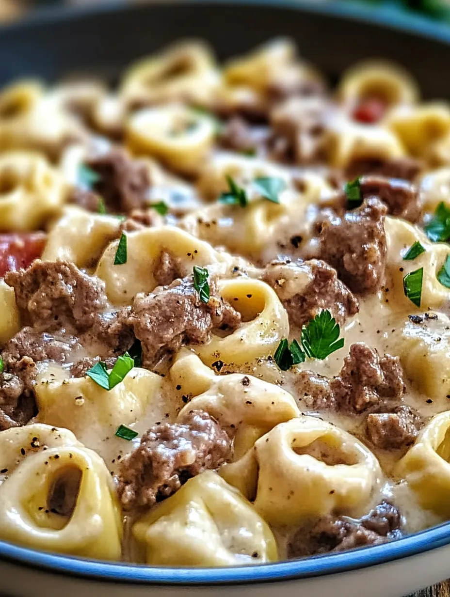 A bowl of pasta with meat and vegetables.