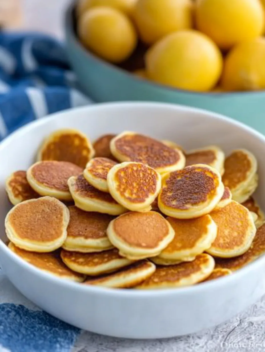 A bowl of pancakes with a lemon on top.