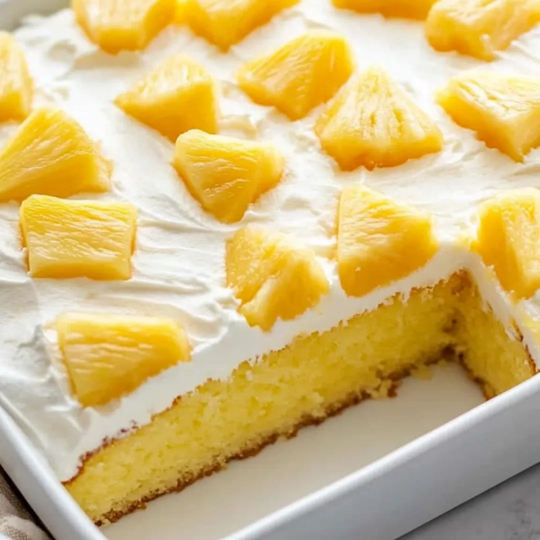 A slice of cake with pineapple on top.