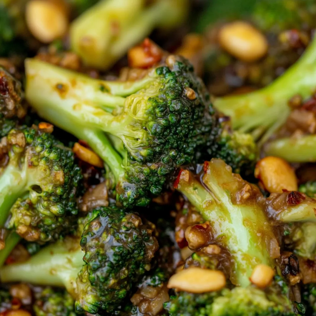 A close up of broccoli with nuts.