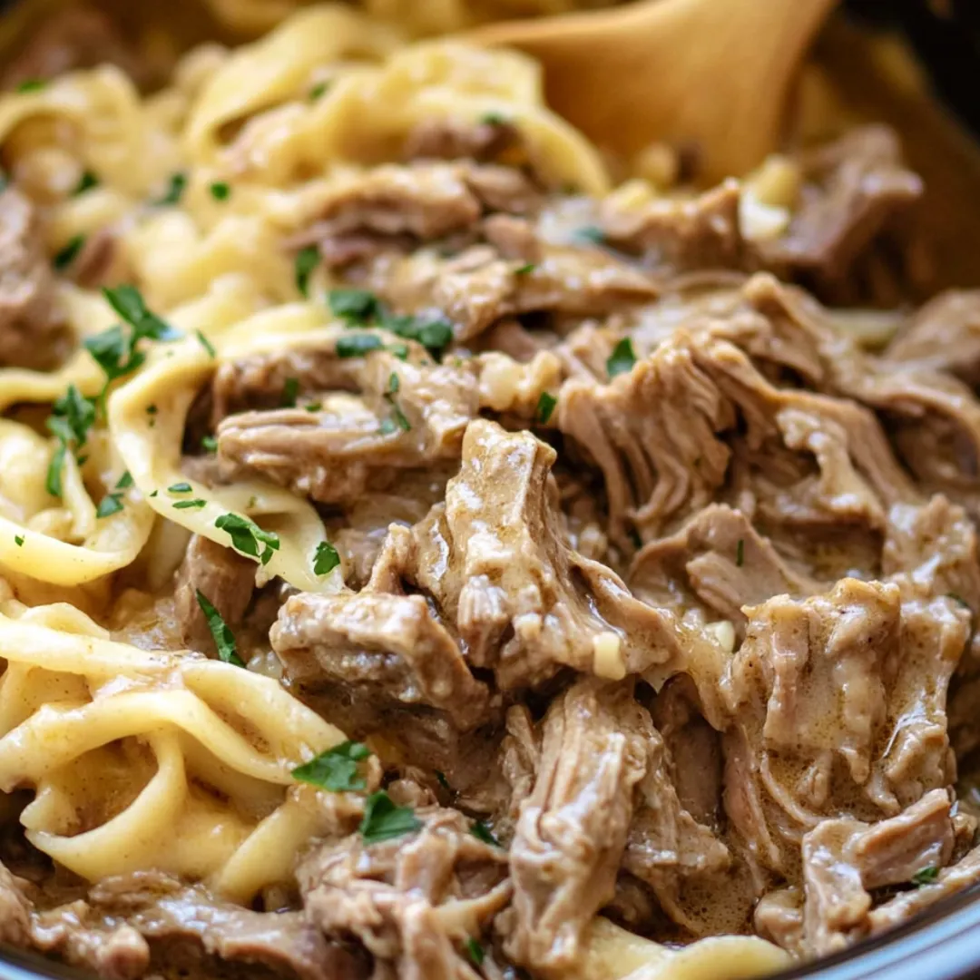 A bowl of pasta with meat sauce.
