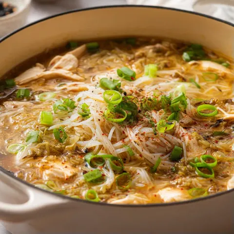 A bowl of soup with noodles and vegetables.