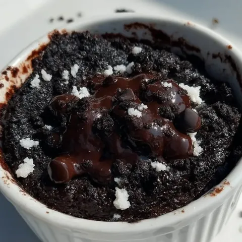 A bowl of chocolate cake with chocolate chips.