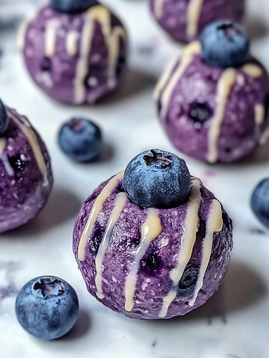 A purple dessert with blueberries on top.