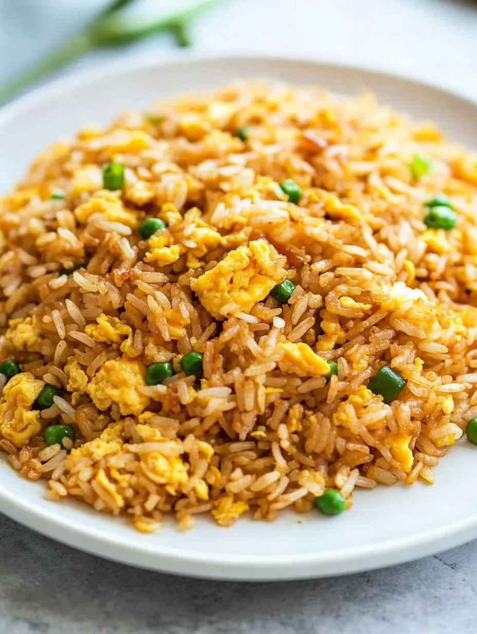 A plate of rice with peas and eggs.