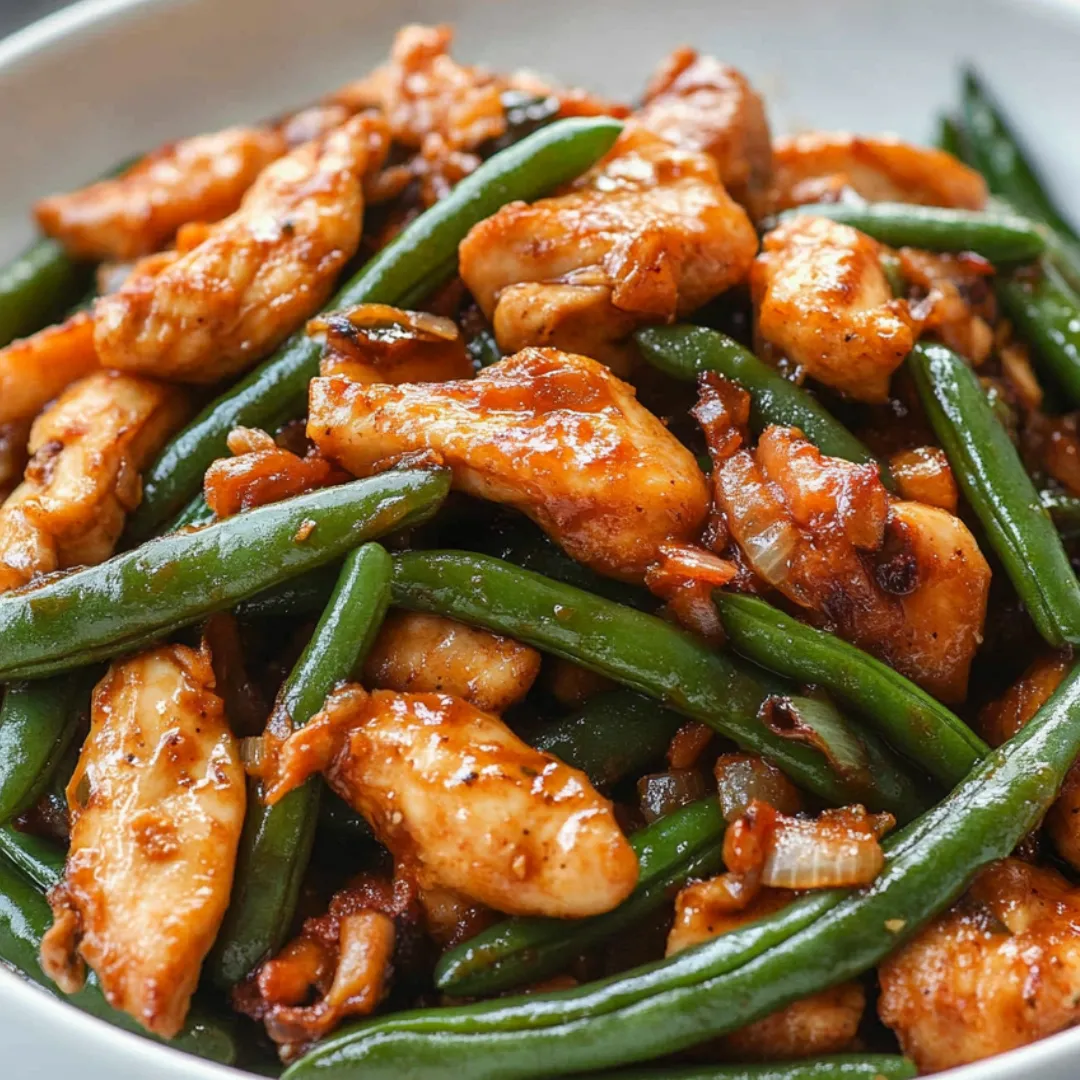 A plate of chicken and green beans.