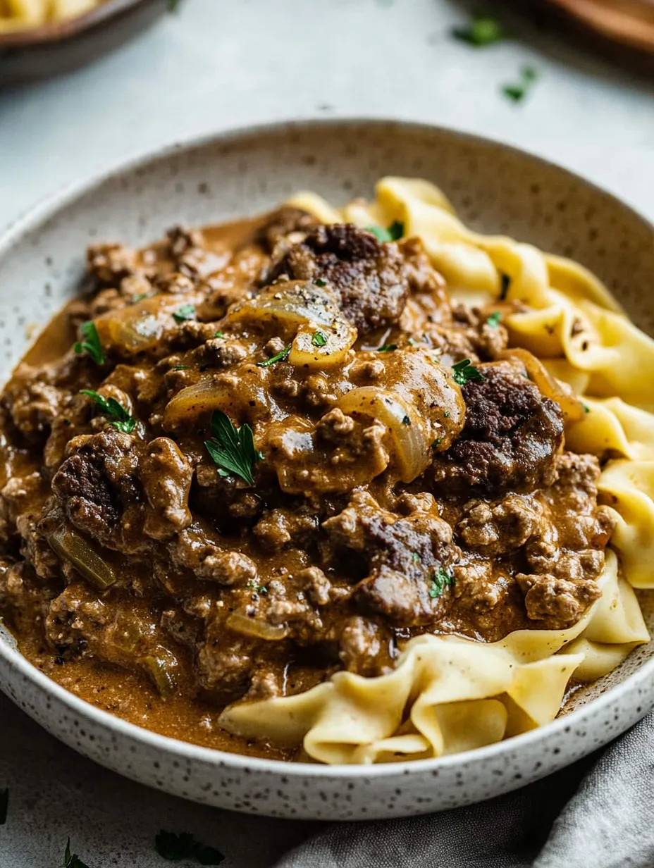 A bowl of pasta with meat sauce.