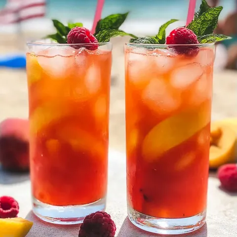 Two glasses of red raspberry lemonade.
