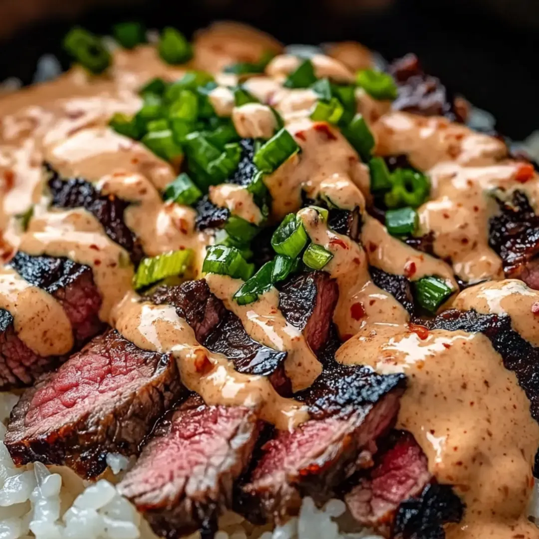 Steak with sauce and rice.