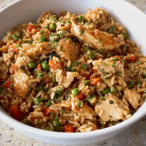 Chicken and rice with veggies in a bowl.