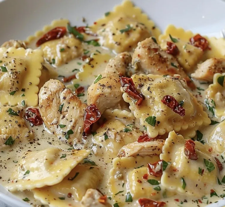 A plate of pasta with chicken and red peppers.