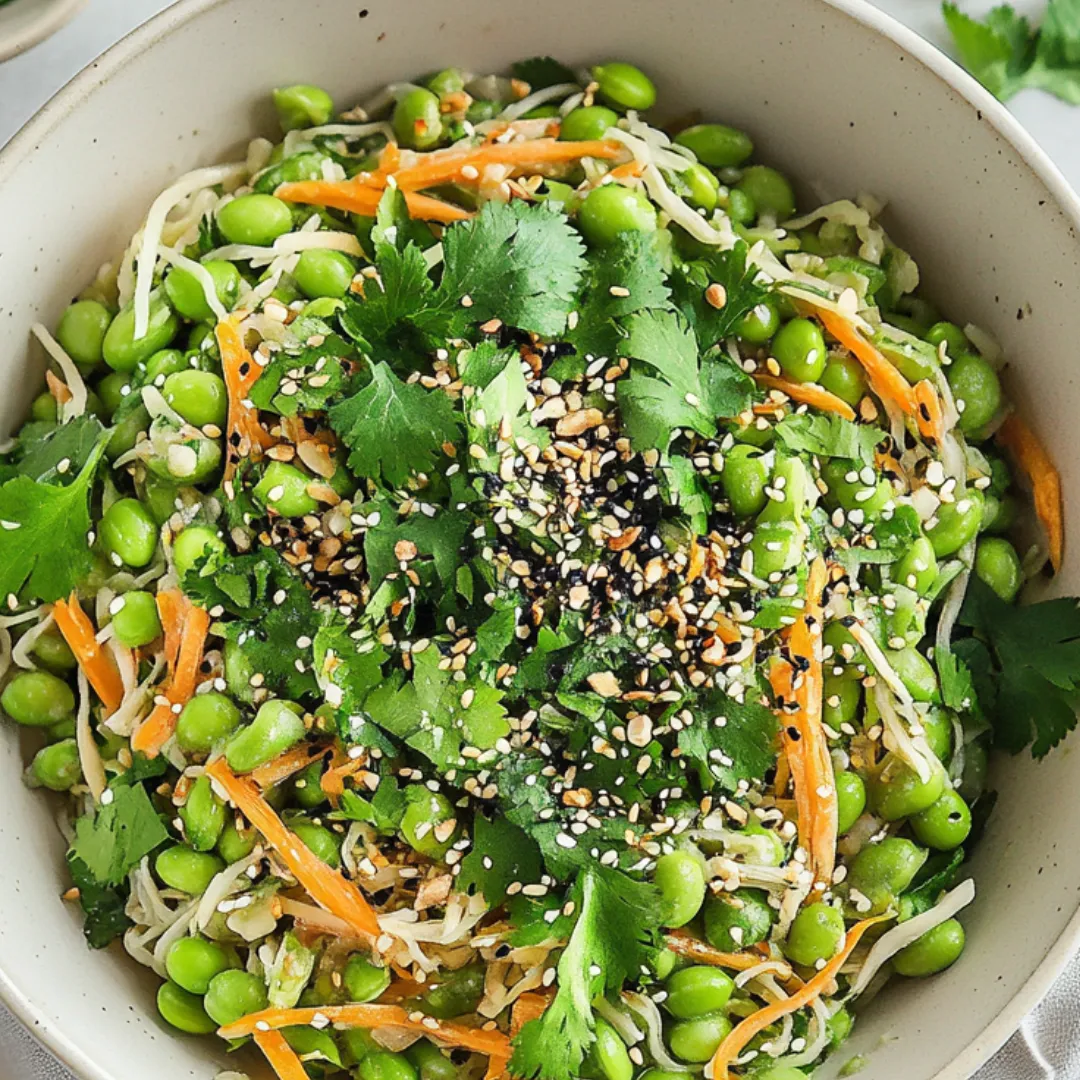 A bowl of noodles with vegetables and spices.