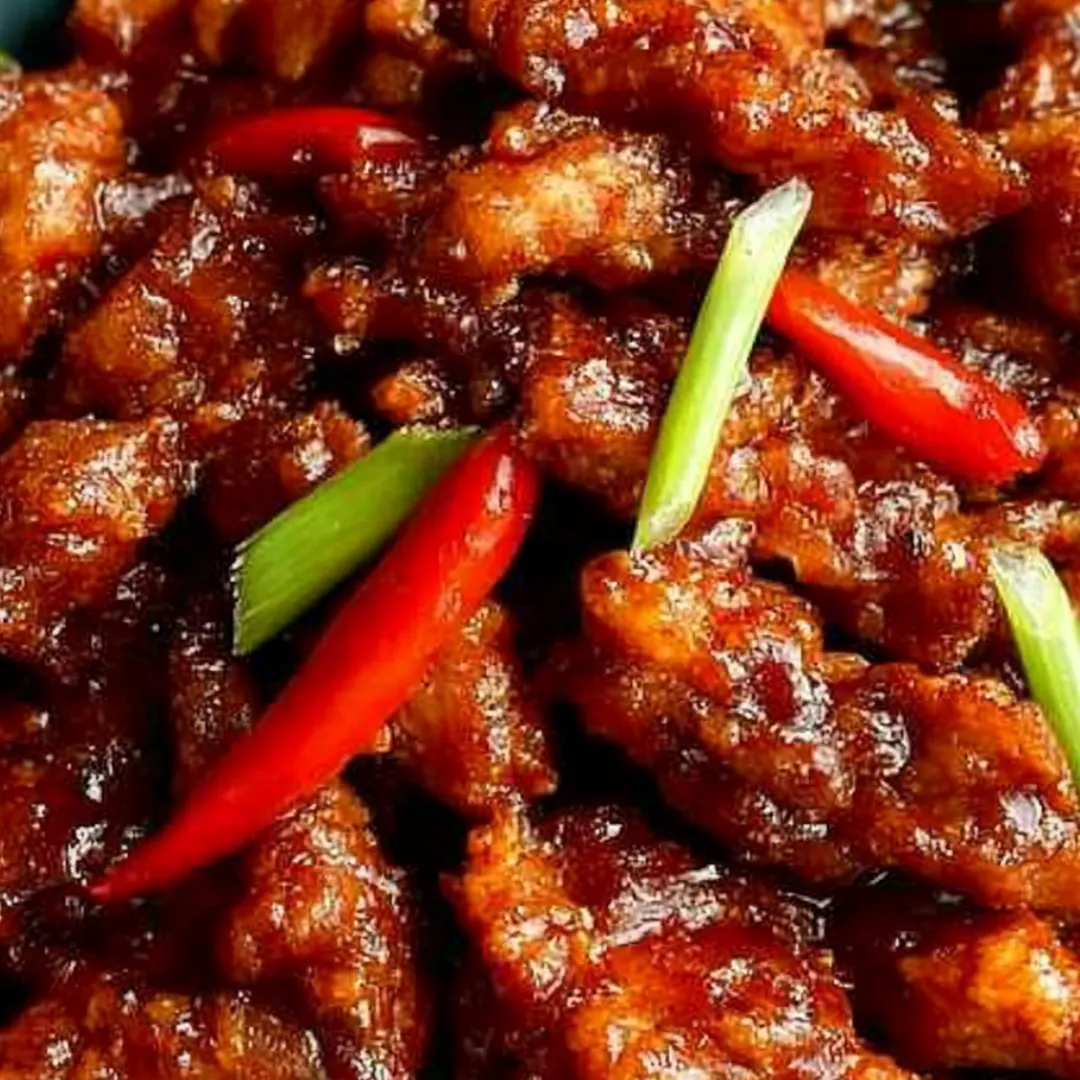 A plate of chicken with peppers.