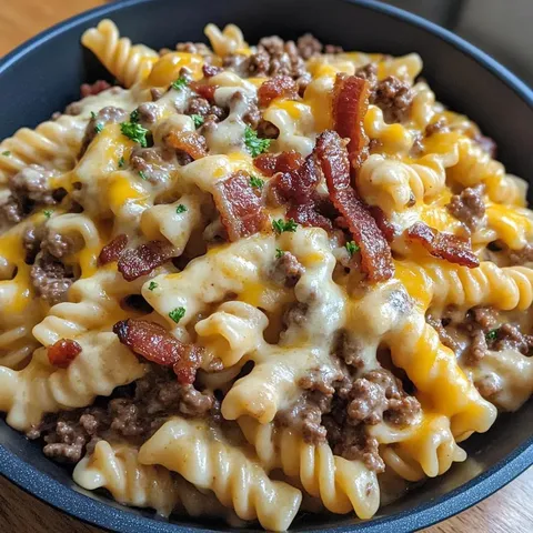 A bowl of pasta with meat and cheese.