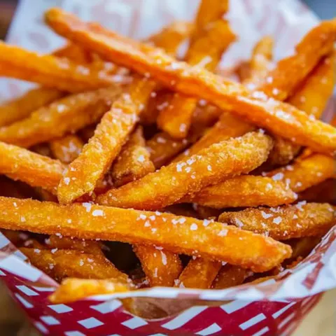 A basket of fries with salt on them.
