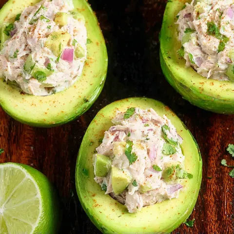 Three avocado halves filled with a creamy salad.