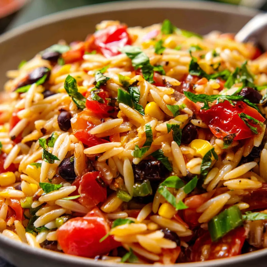 A bowl of rice with tomatoes and green onions.