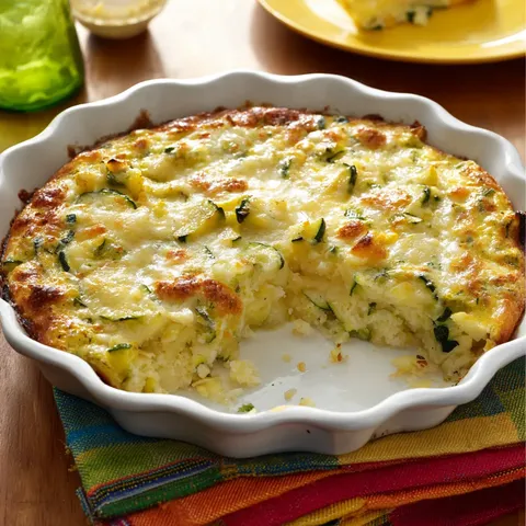 A slice of quiche is on a plate.