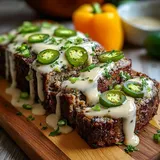 A piece of meat with jalapenos on it.
