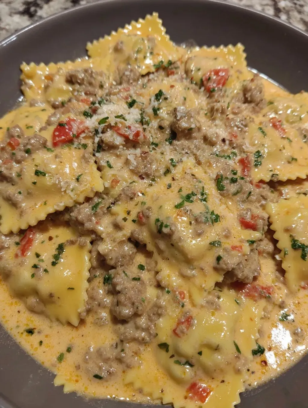 A plate of pasta with meat sauce.
