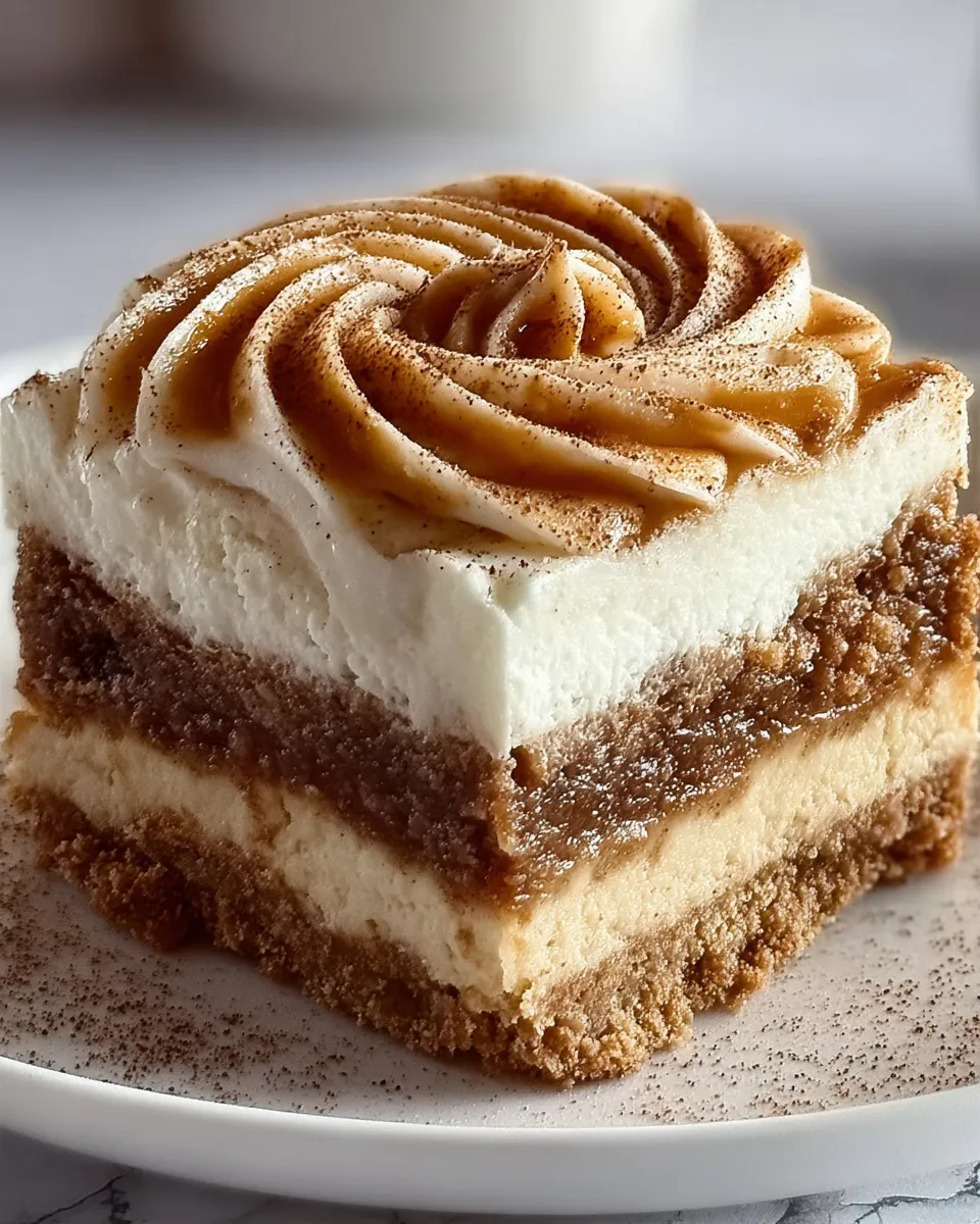 A slice of cake with a swirl of frosting.
