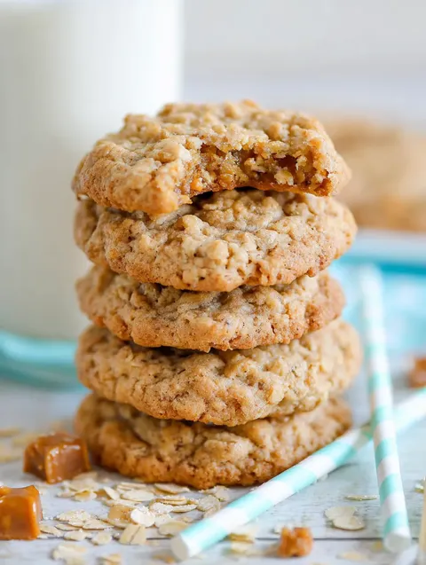 A stack of cookies with a glass of milk.