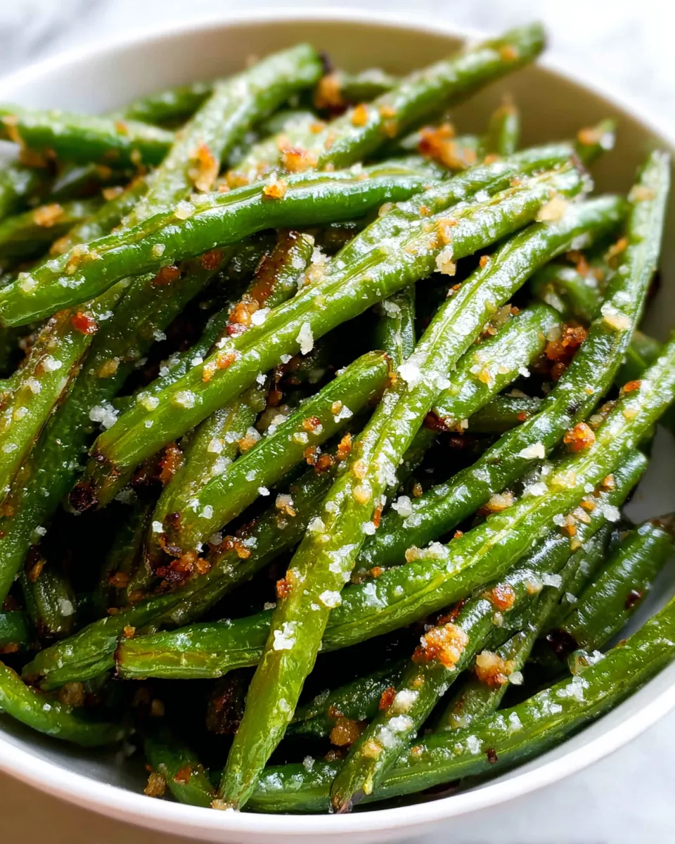 A bowl of yummy green beans with seasoning.