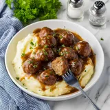 A plate of food with meatballs and mashed potatoes.