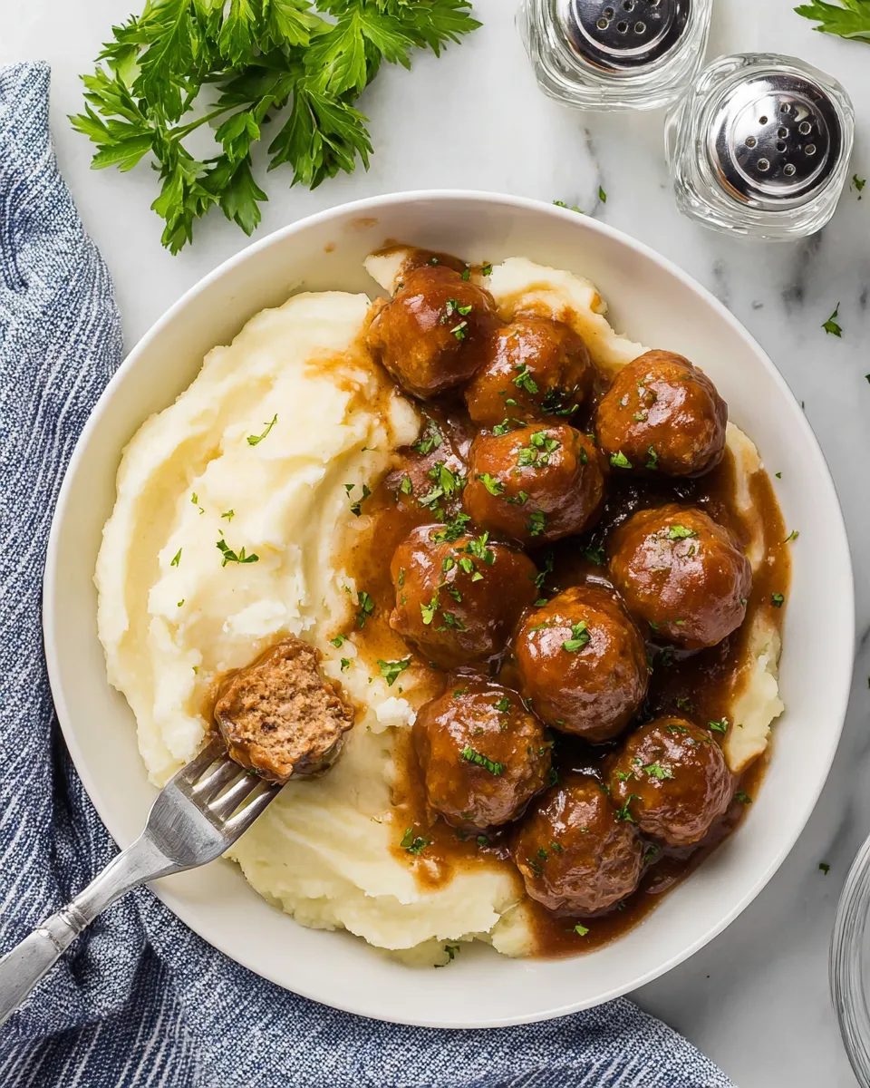 A plate of food with meatballs and mashed potatoes.