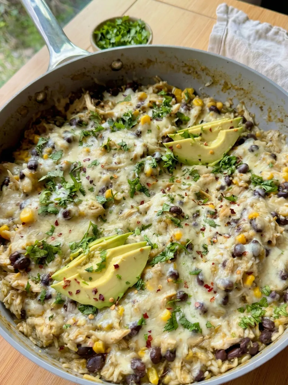 A dish with a variety of ingredients including corn, beans, and avocado.
