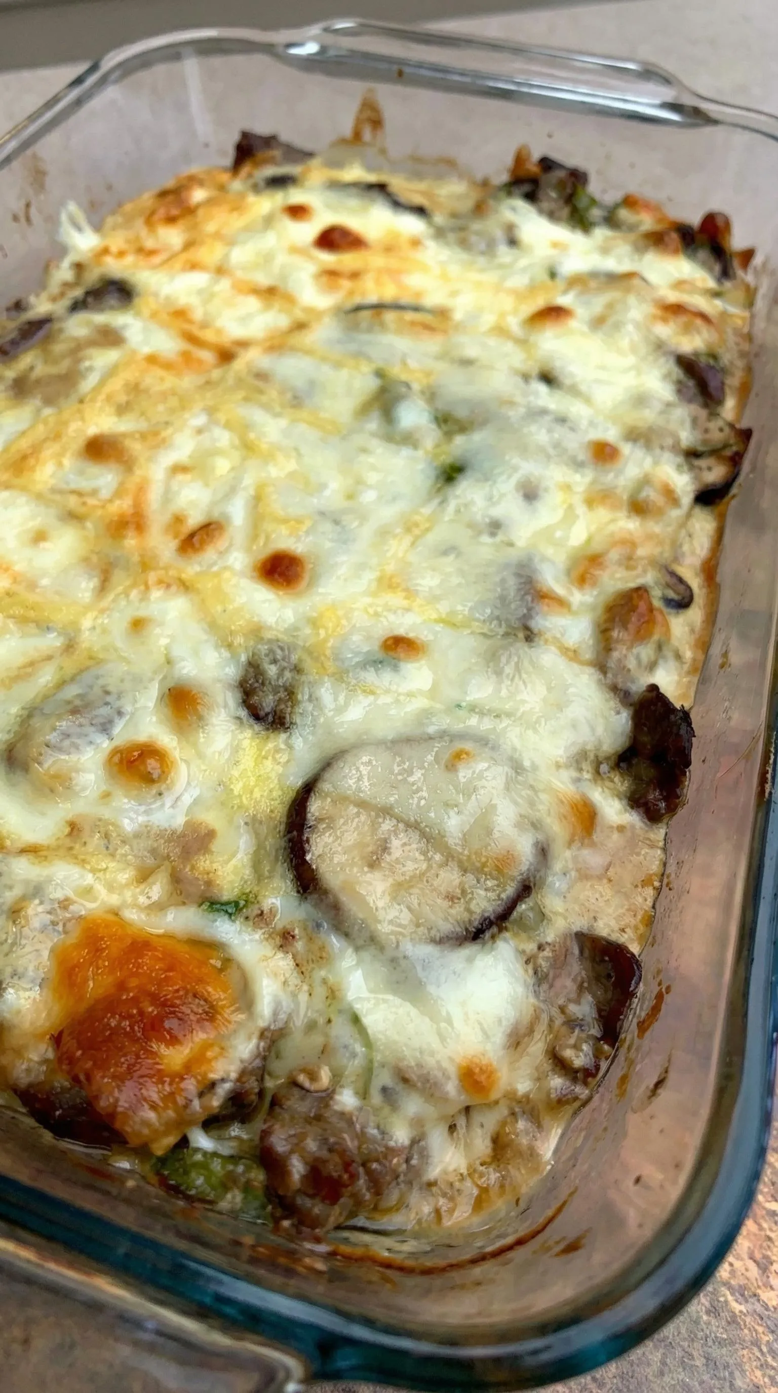 A close up of a cheese and mushroom pizza.