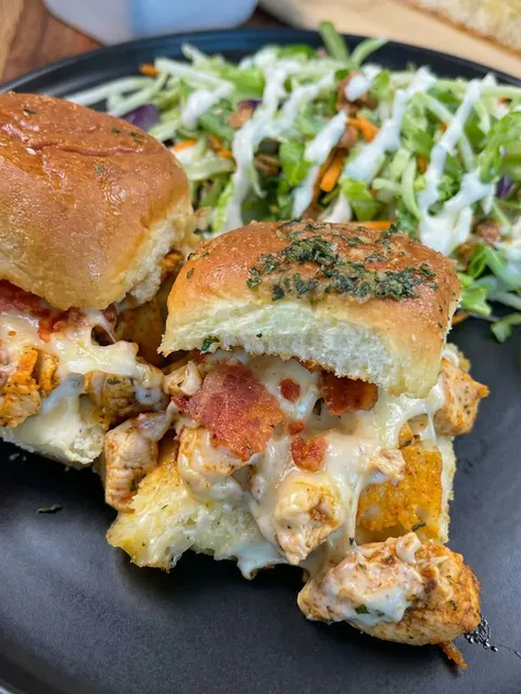 A sandwich with meat and cheese on a plate.