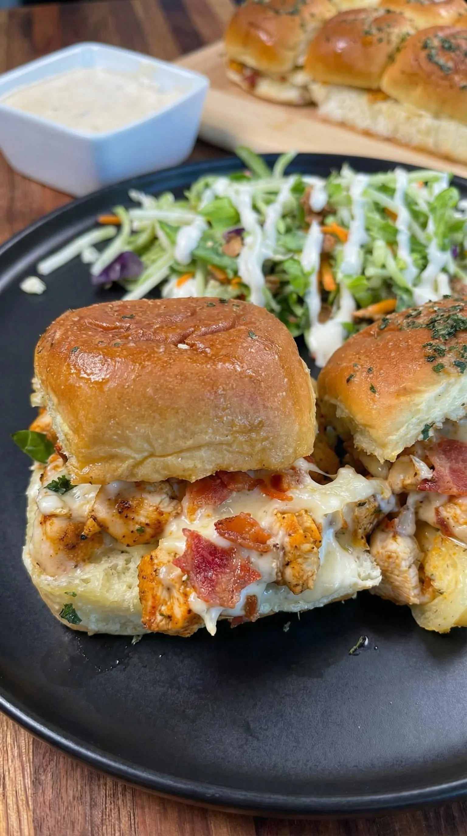 A sandwich with bacon and cheese on a plate.