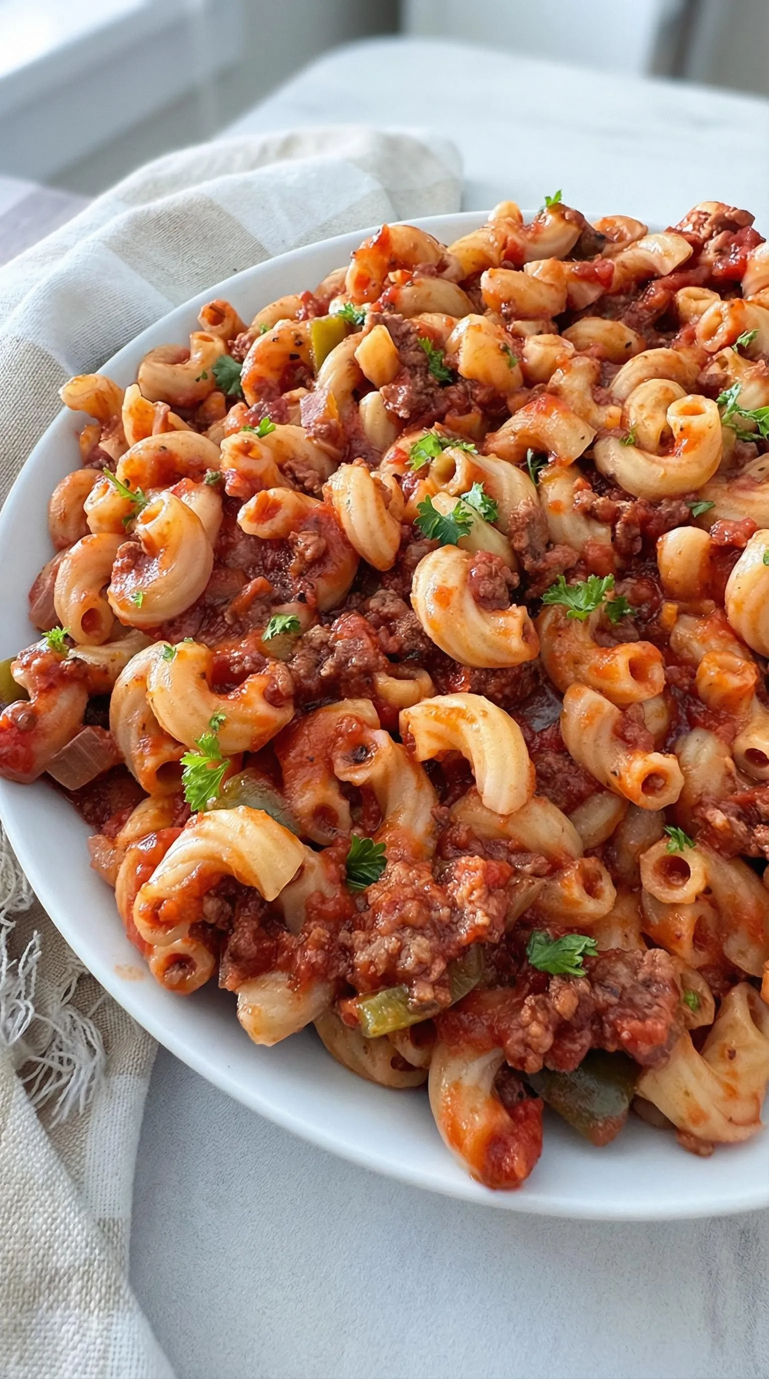 A plate of pasta with meat sauce.
