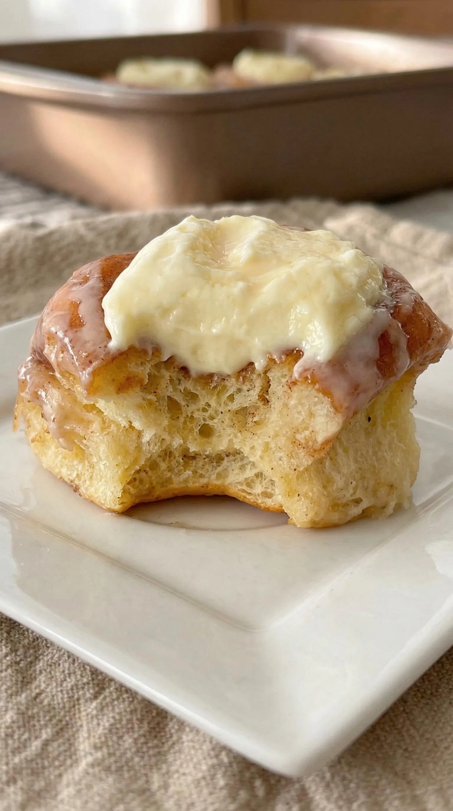 A glazed donut with white frosting.