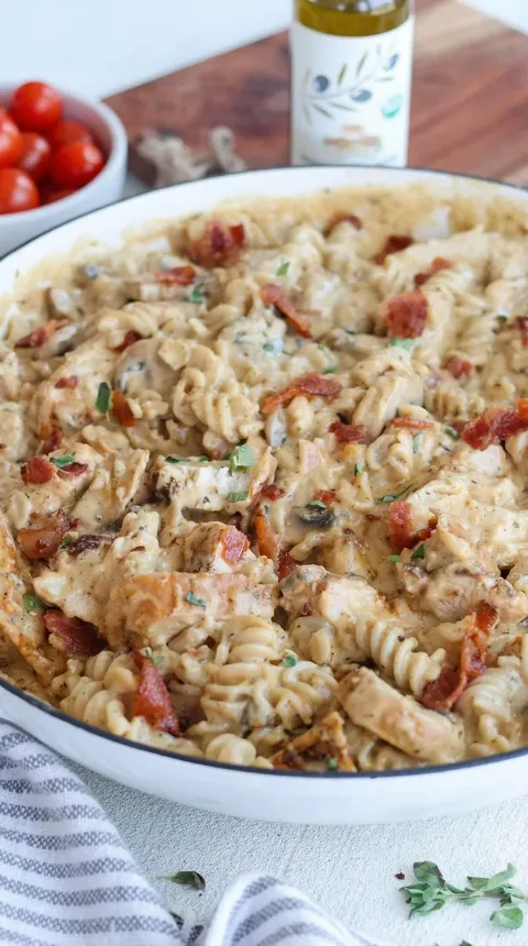 A plate of food with bacon and mushrooms.